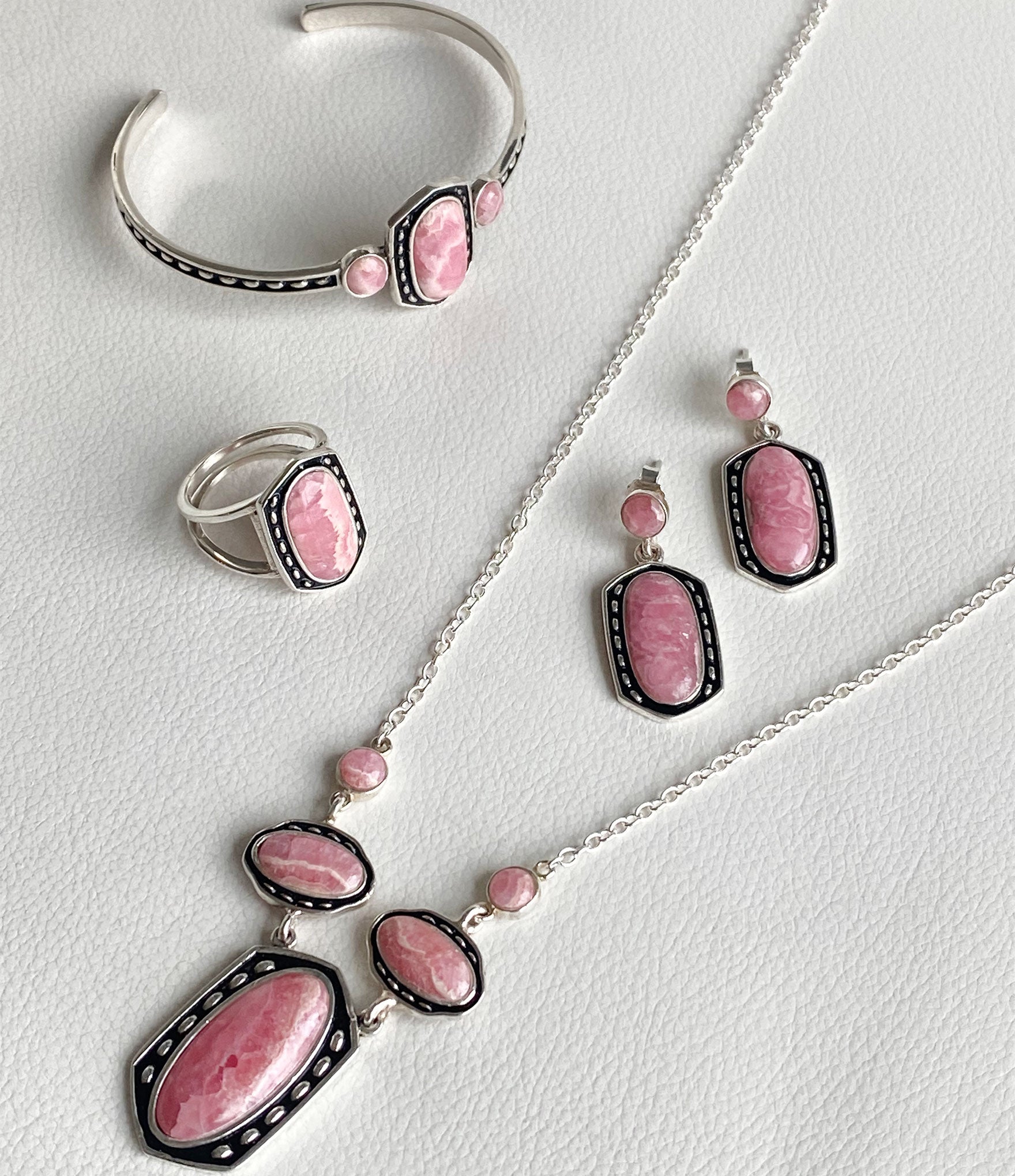 Jewelry set with pink stones on a white background