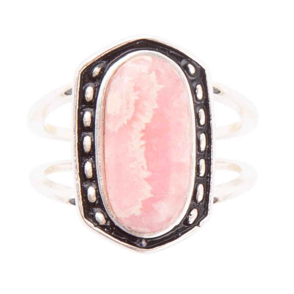 Ring with a pink stone and silver accents on a white background