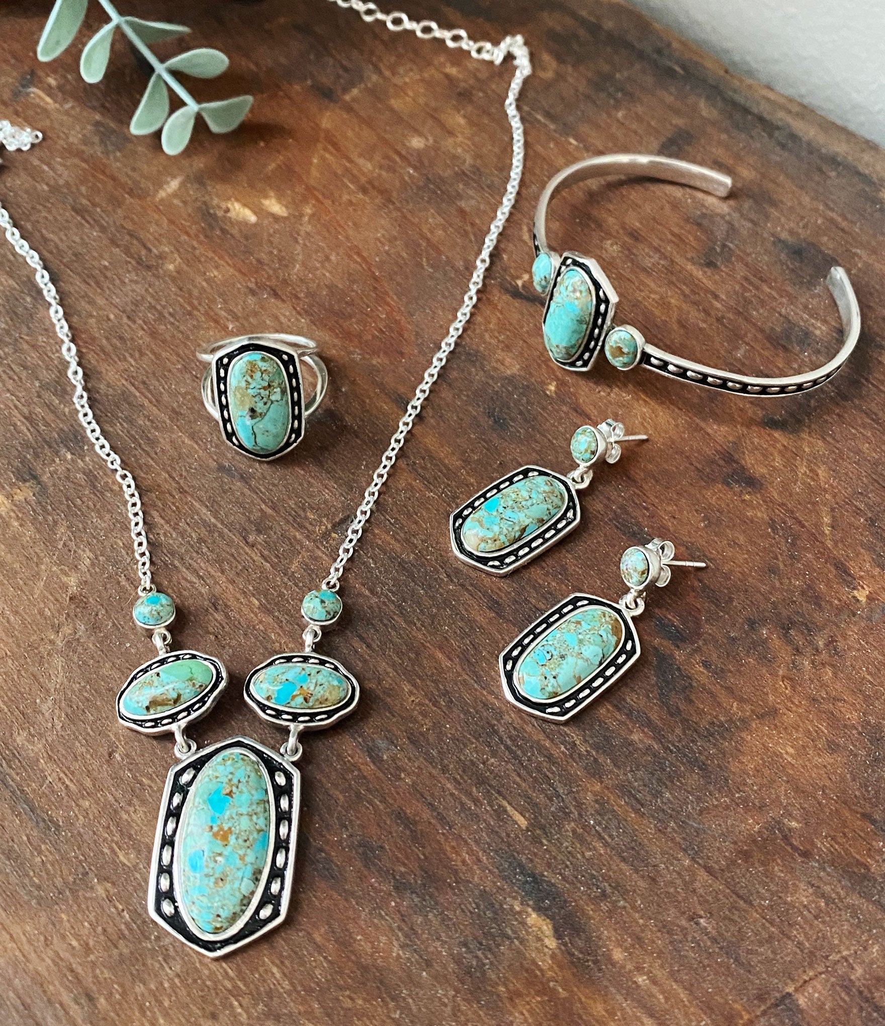 Jewelry set with turquoise stones on a wooden surface
