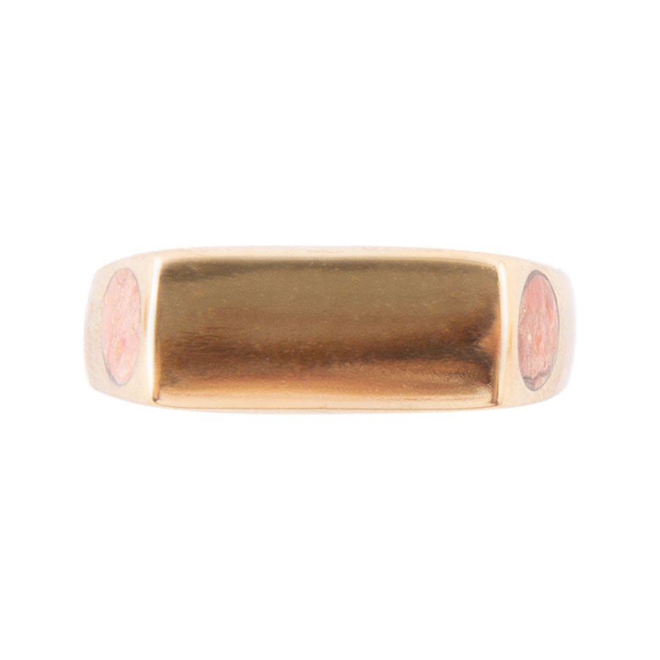 Gold ring with pink stones on a white background