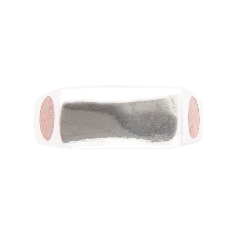 Metallic silver object with pink circular ends on a white background