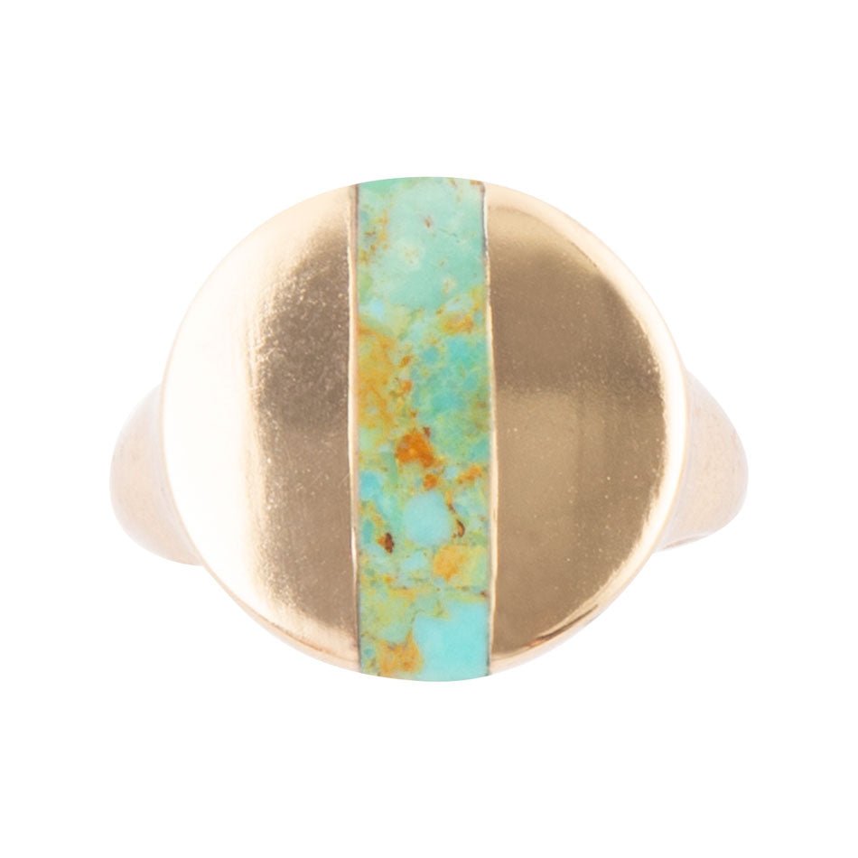 Gold ring with a turquoise stone on a white background