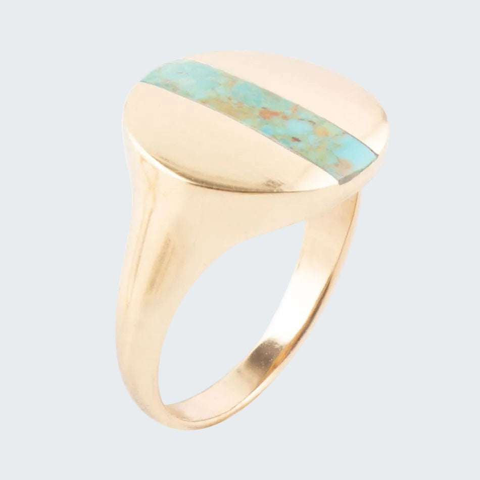 Gold ring with a turquoise stone on a white background