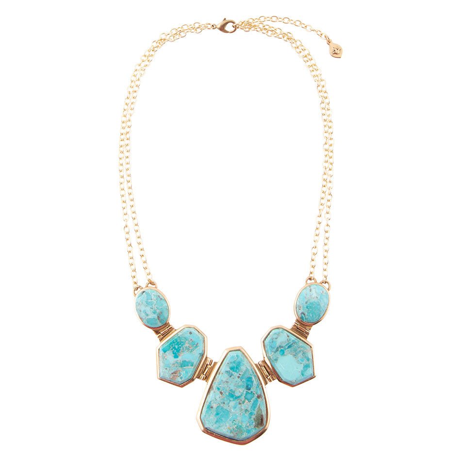 Turquoise necklace with gold accents on a white background