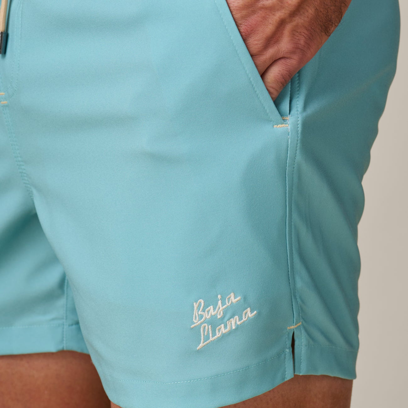 Light blue shorts with 'Baja Llama' branding on a neutral background
