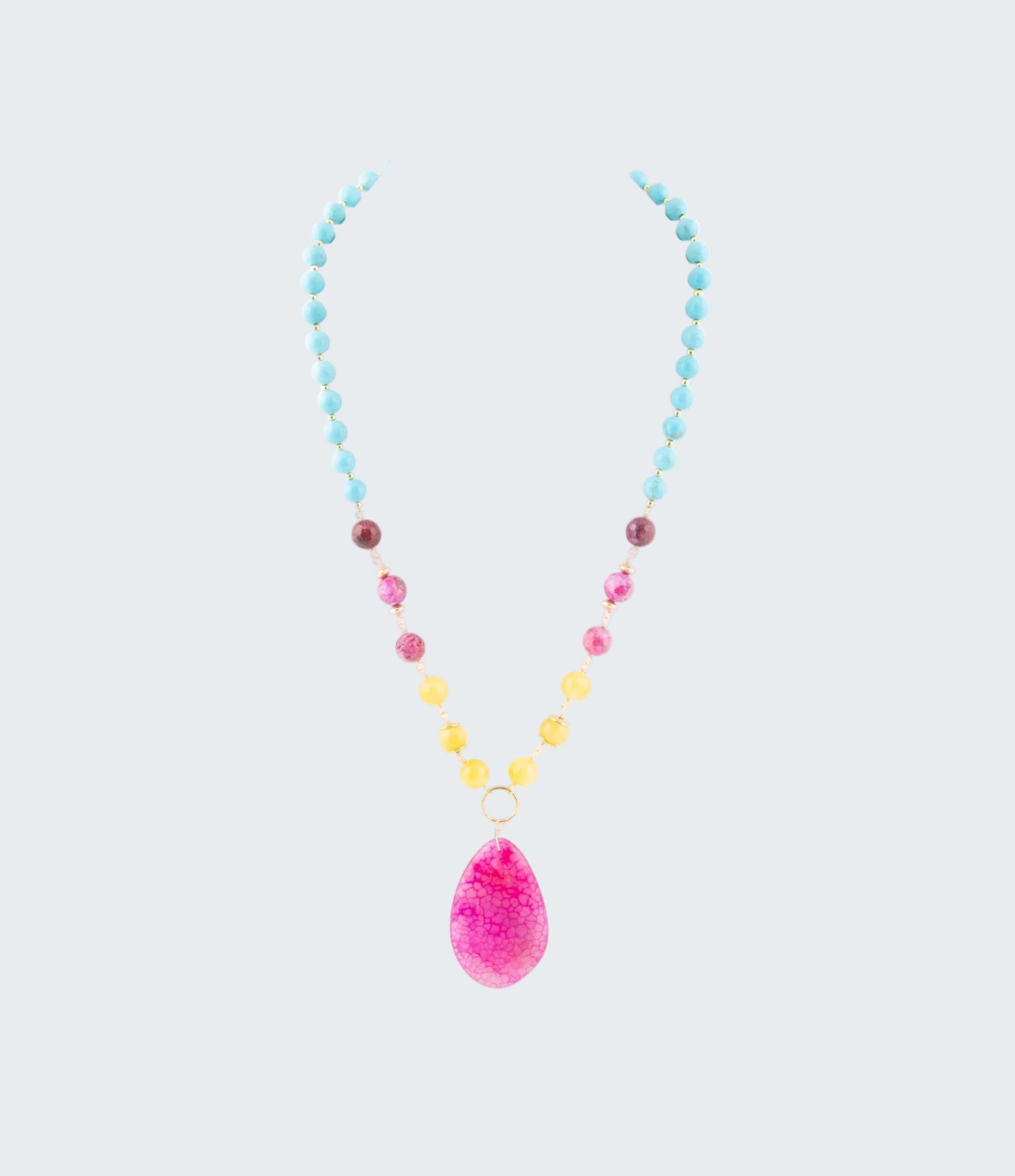 Necklace with colorful beads and a pink teardrop pendant on a white background