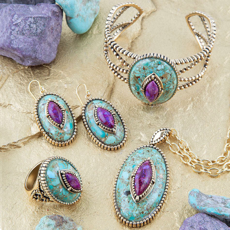 Jewelry set with turquoise and purple stones on a stone surface