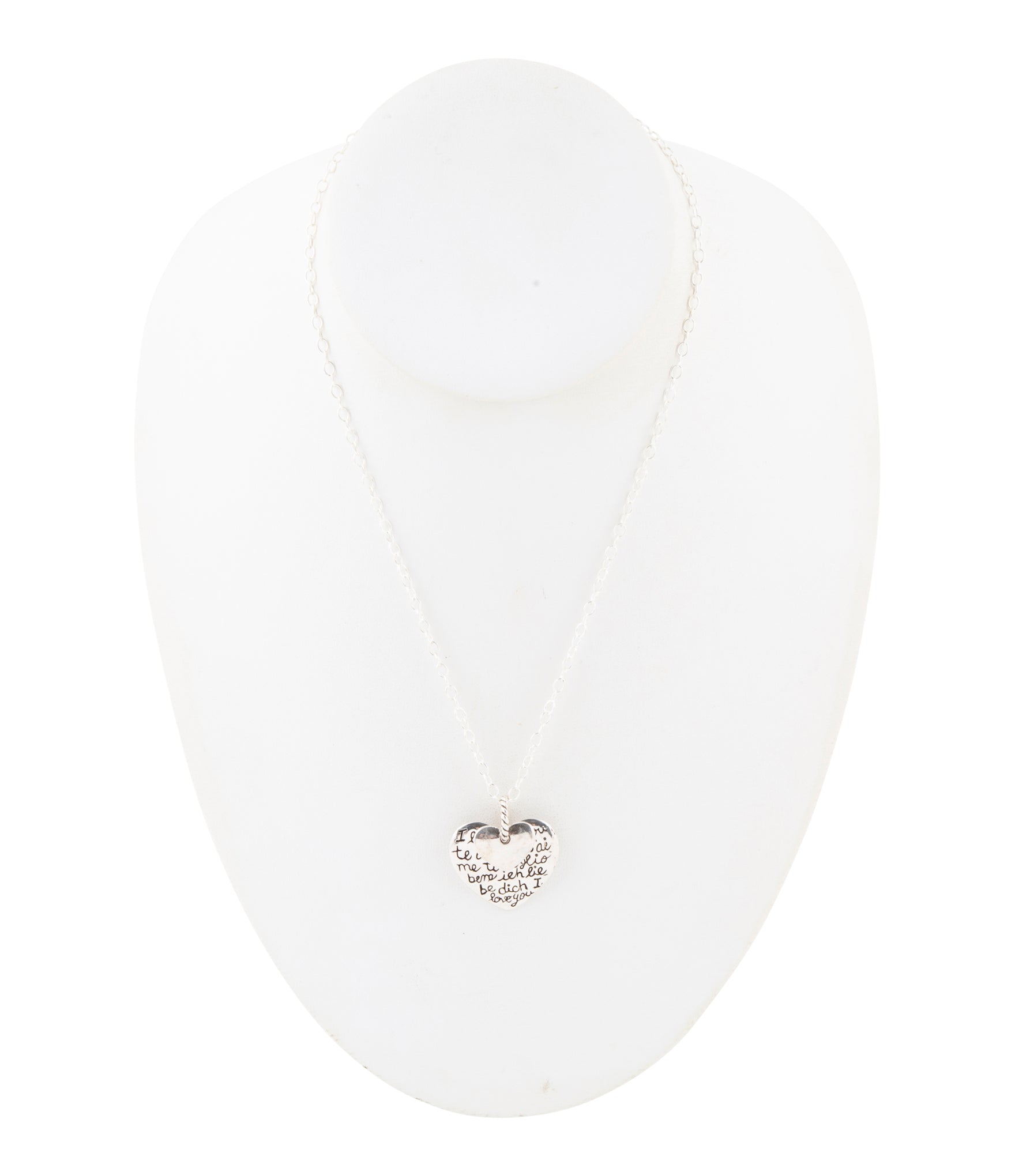 White sandal with a small decorative heart on a white background