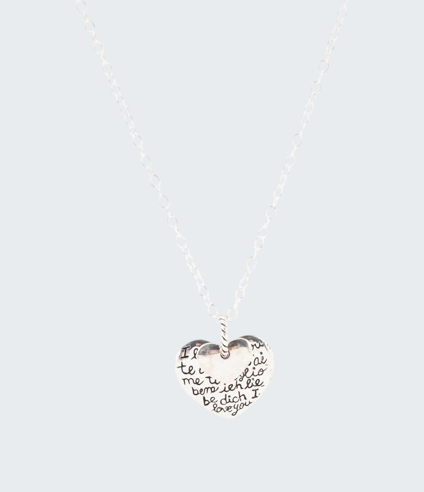Heart-shaped pendant necklace with engraved text on a white background