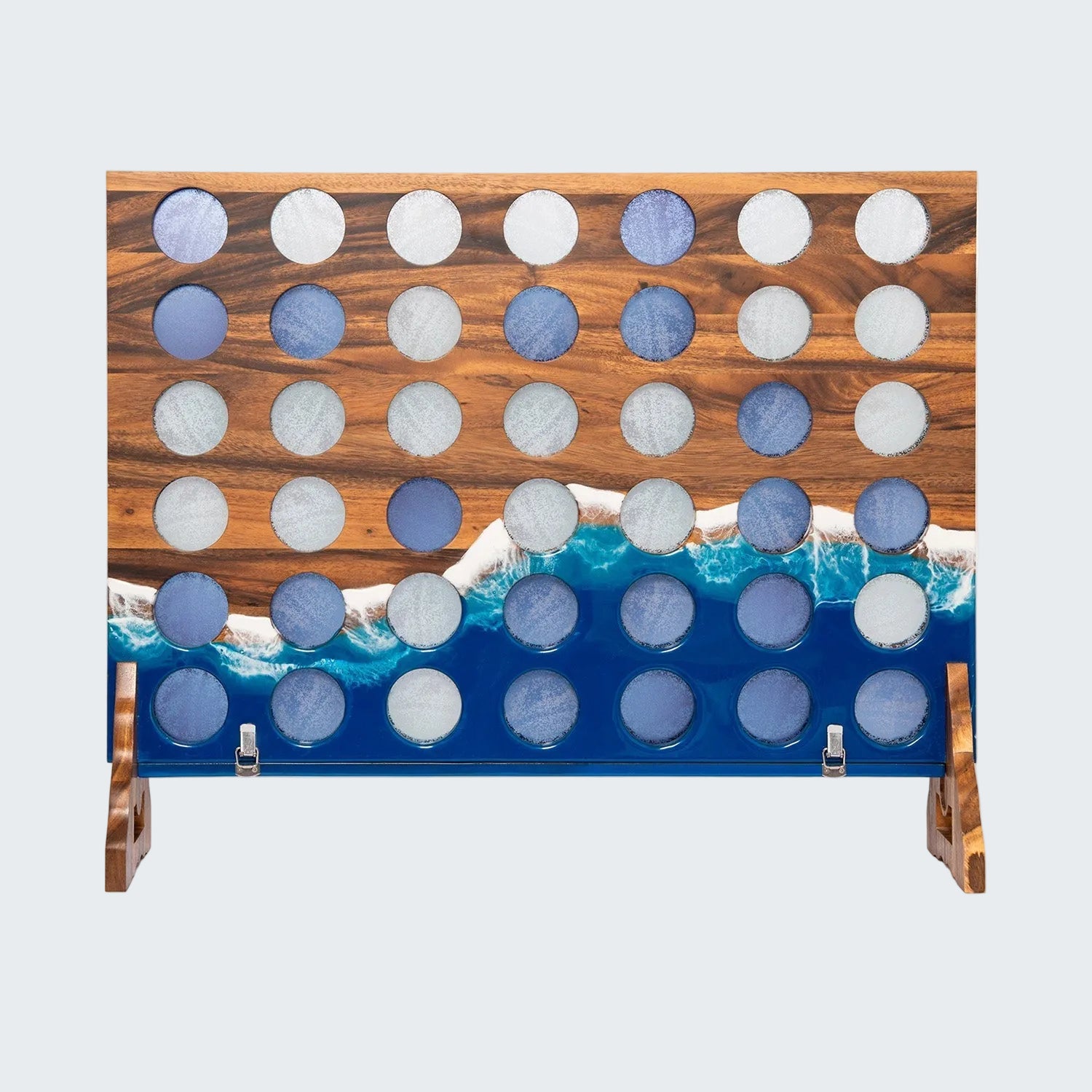 A wooden Connect 4 game board with a natural wood grain top section, a blue and white wave-patterned bottom section, and circular slots containing blue and white discs, shown on a white background.