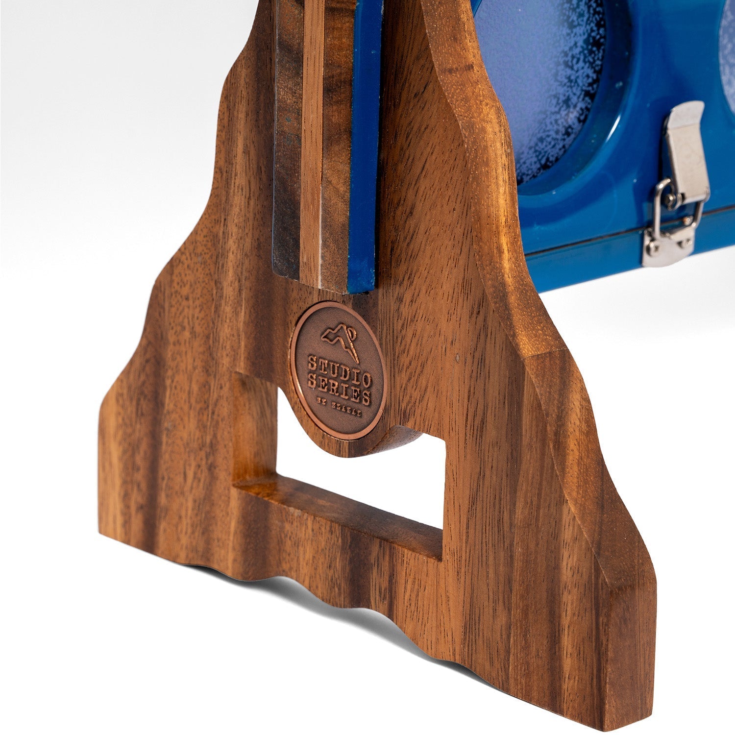 Close-up of a wooden golf club headrest with a circular 'Sergio Strehlow' logo medallion, set against a blue and black golf club case on a white background.