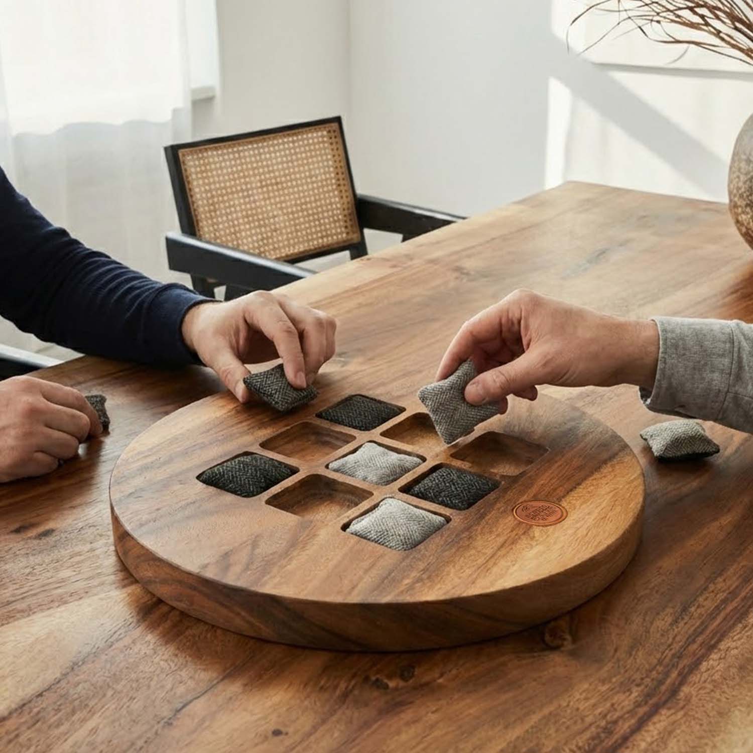 Two people playing a game with wooden tiles on a wooden table.