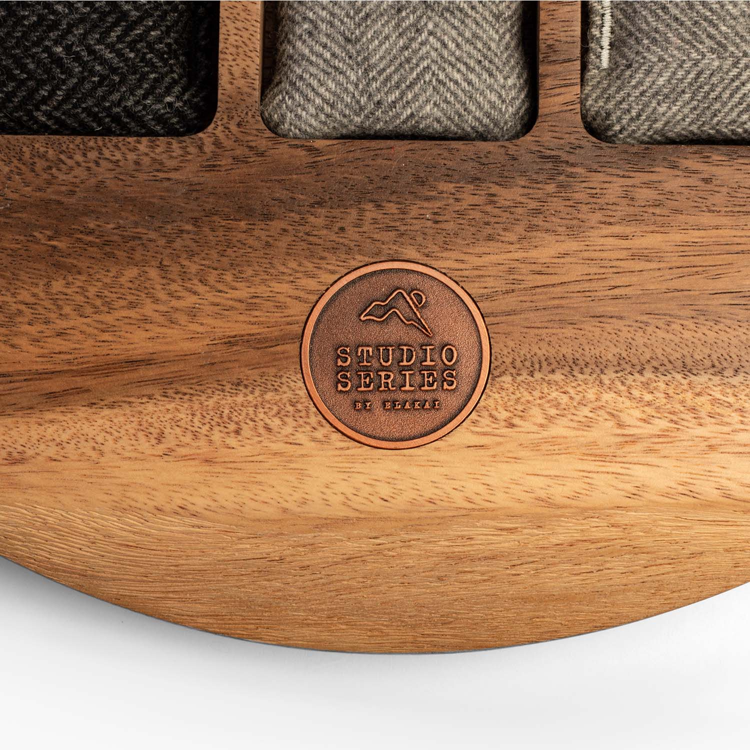 Wooden product with 'Studio Series' logo and fabric swatches on a white background