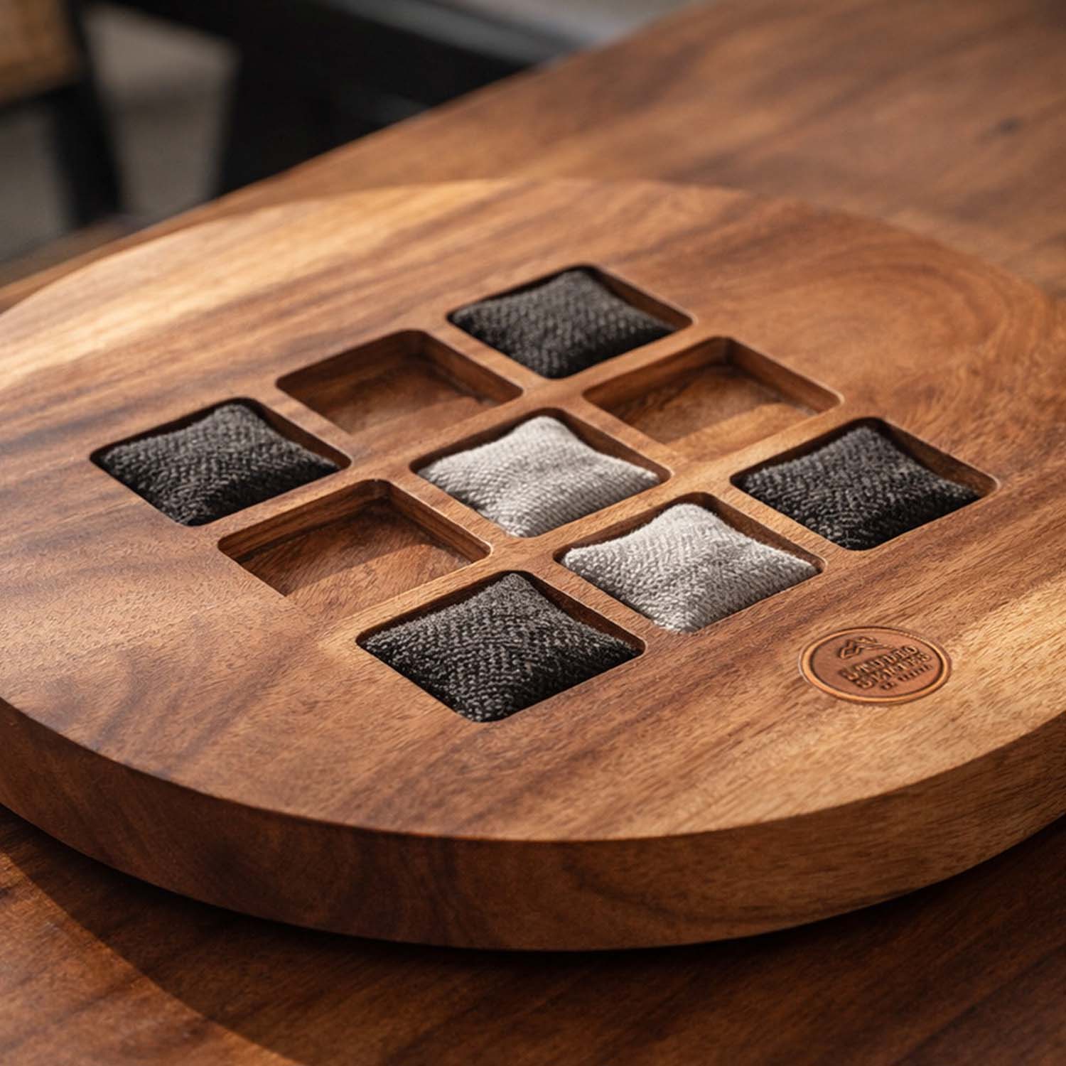 Wooden coaster set with fabric samples on a wooden surface