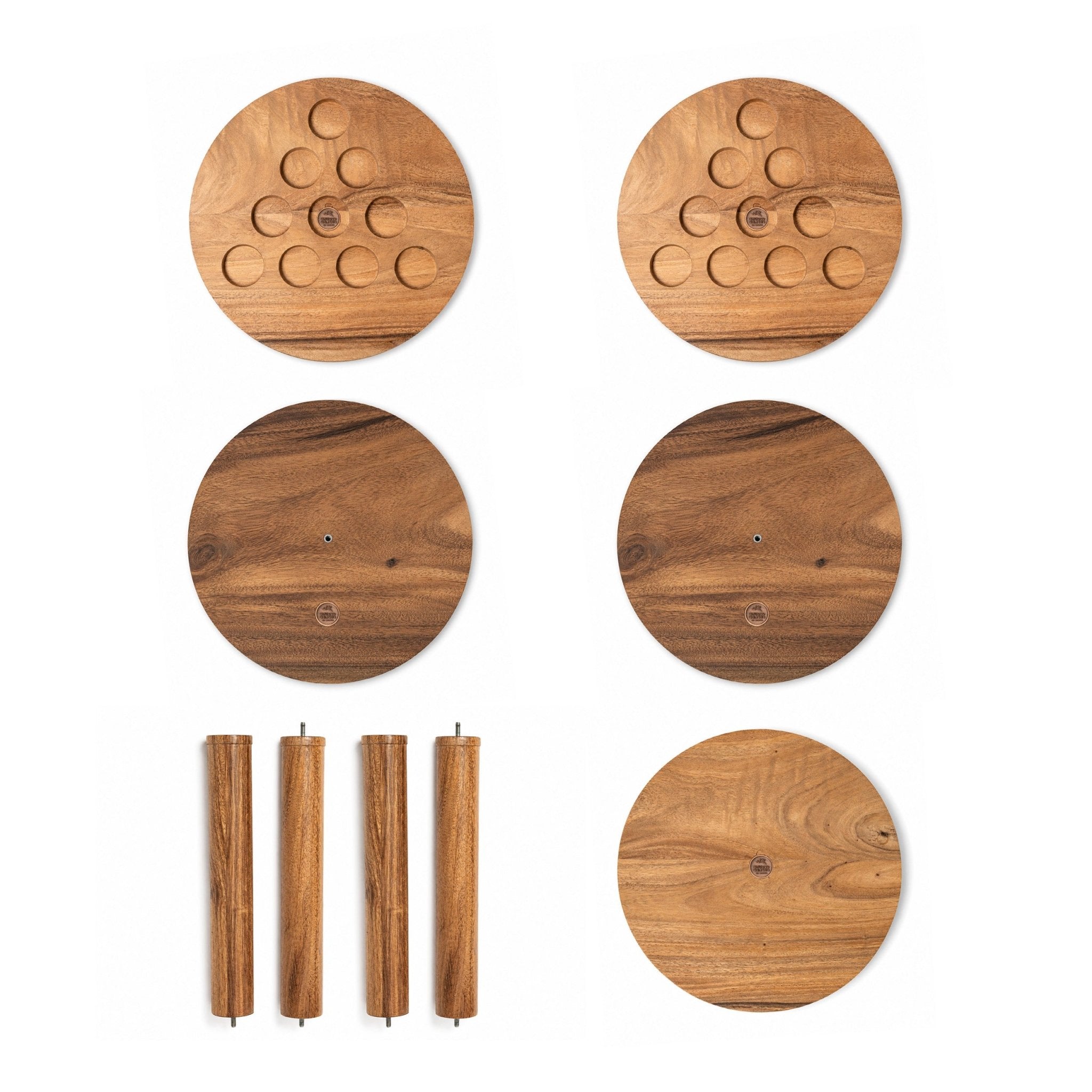 A set of round wooden game pieces or board components with visible wood grain, shown on a plain white background. The set includes several circular pieces with cutout circles and four cylindrical pieces with small metal pins at the ends.
