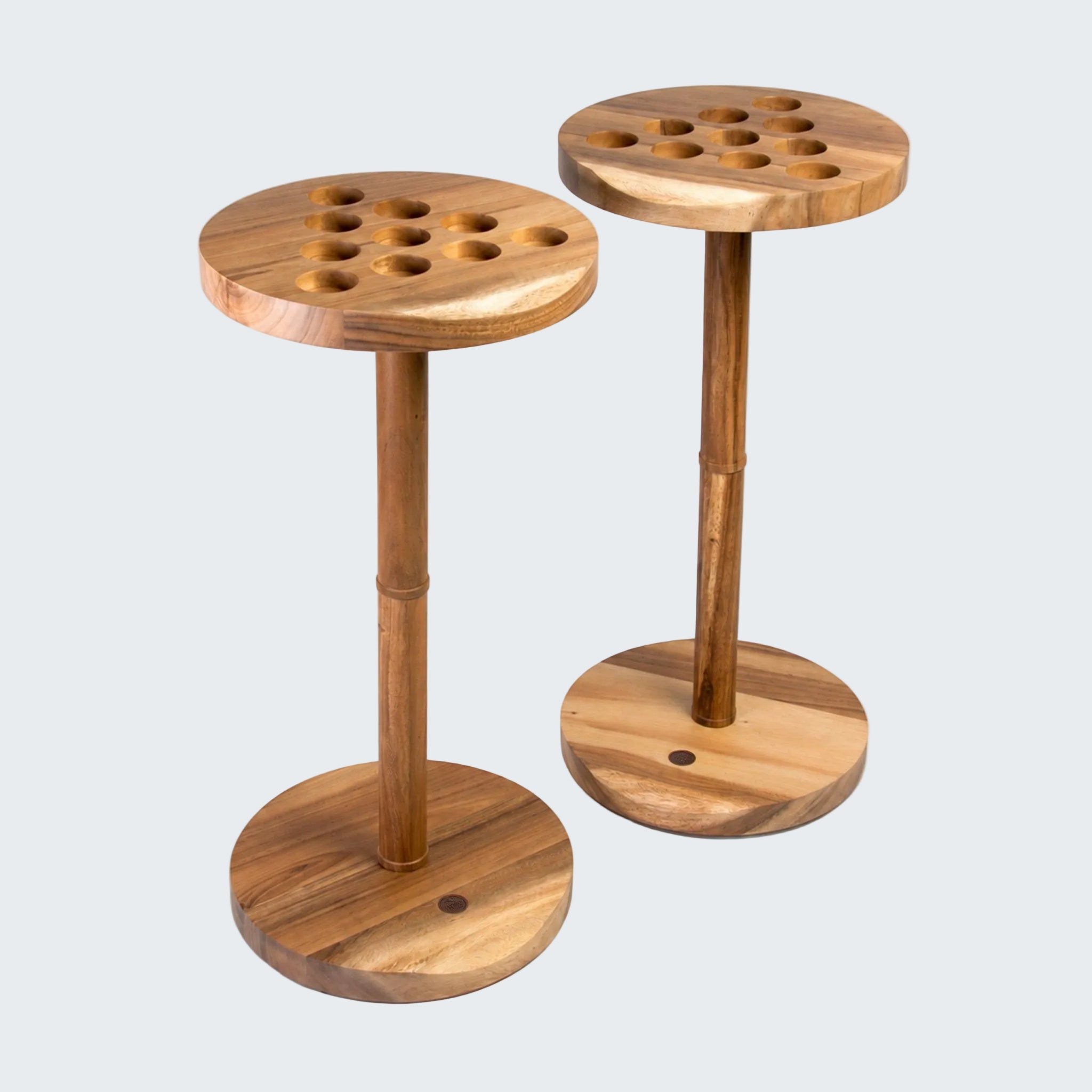 Two round wooden game tables with peg-hole tops and circular bases, shown on a clean white background.