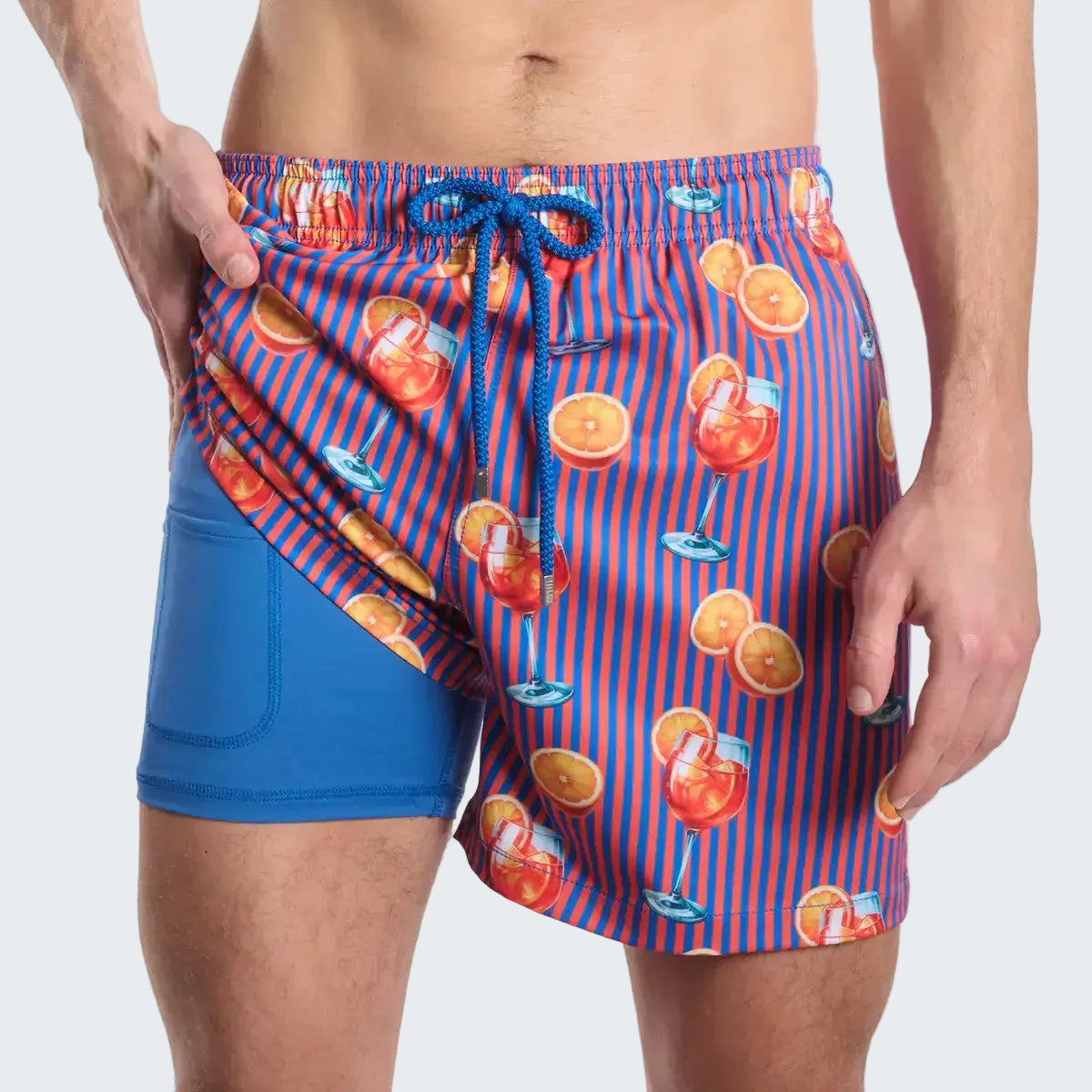 Blue swim shorts with orange juice pattern on a white background