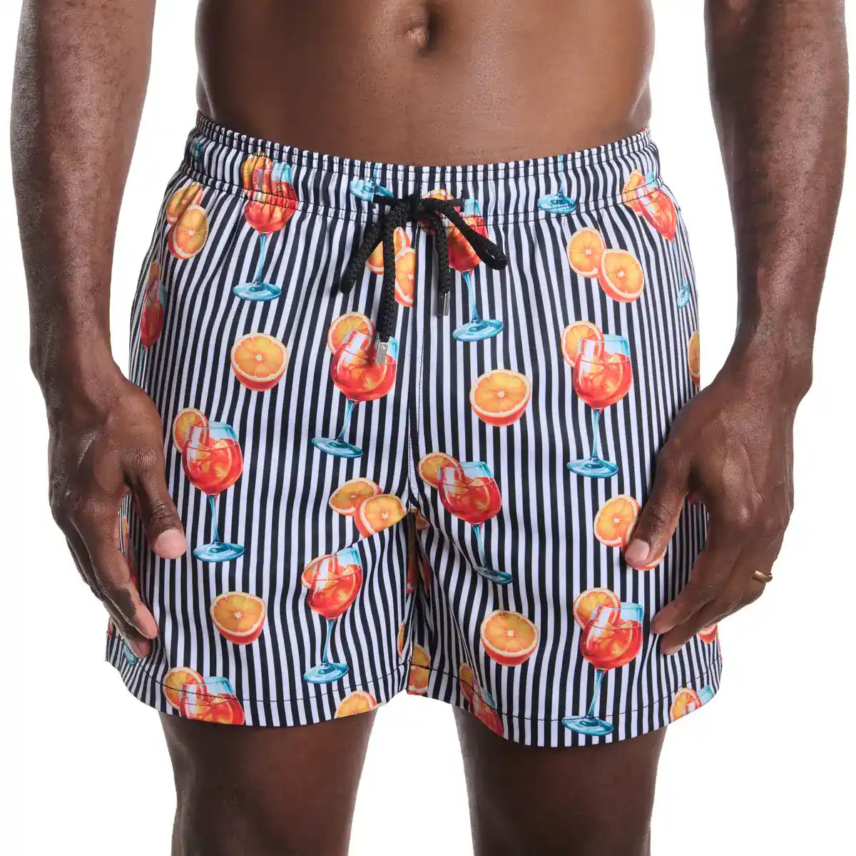 Striped swim shorts with fruit and drink pattern on a white background