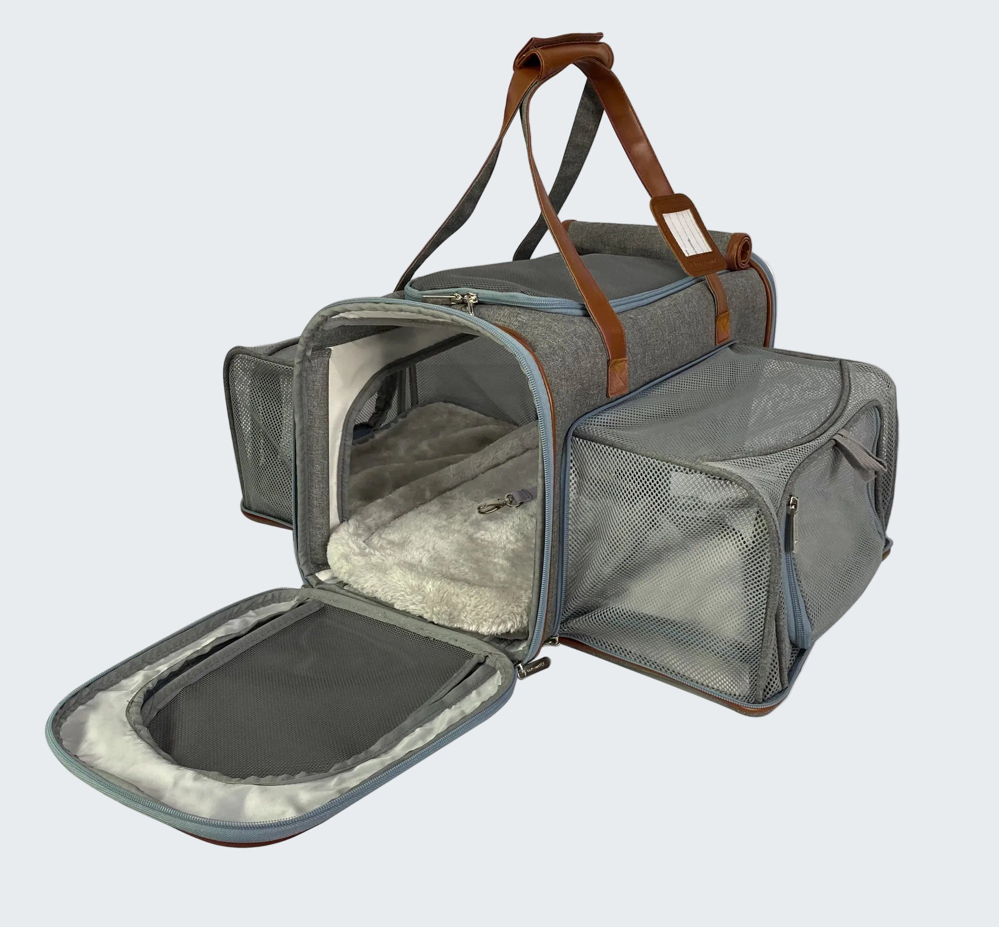 Gray pet carrier with open door on a white background