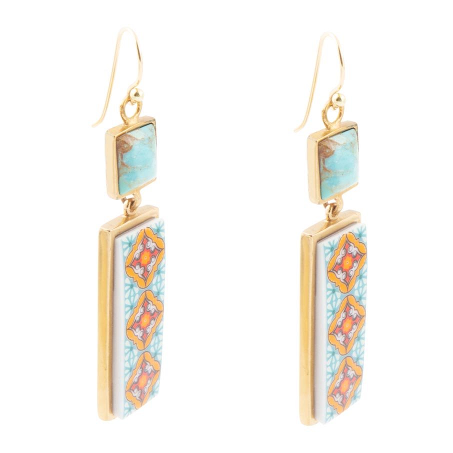 Gold earrings with turquoise and orange gemstones on a white background