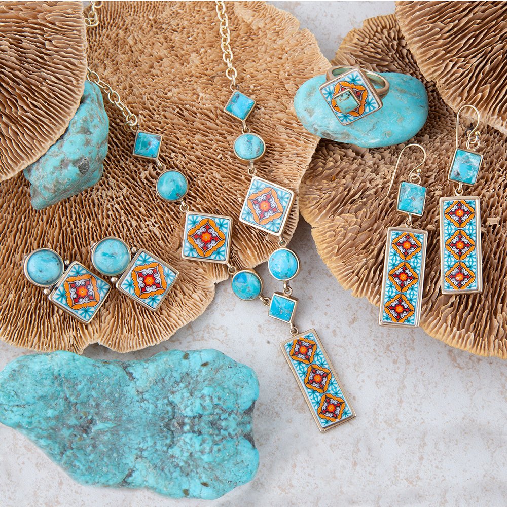 Jewelry set with turquoise stones and decorative elements on a textured surface