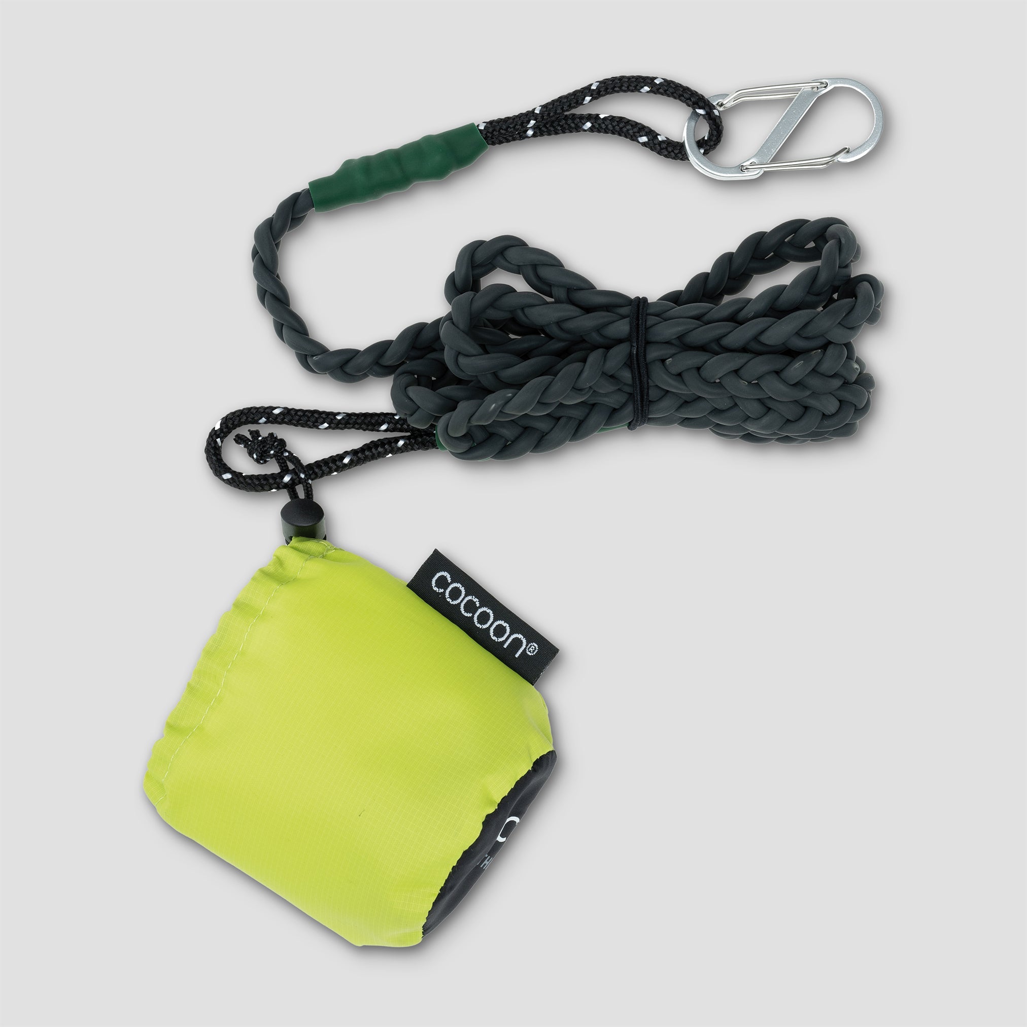 Green pouch with rope and carabiner on a light gray background
