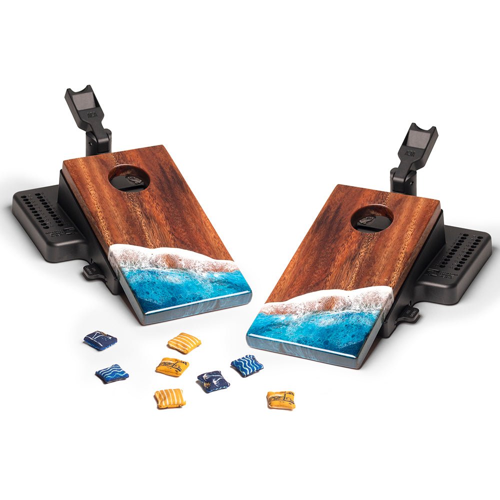 Wooden cornhole boards with ocean design on a white background