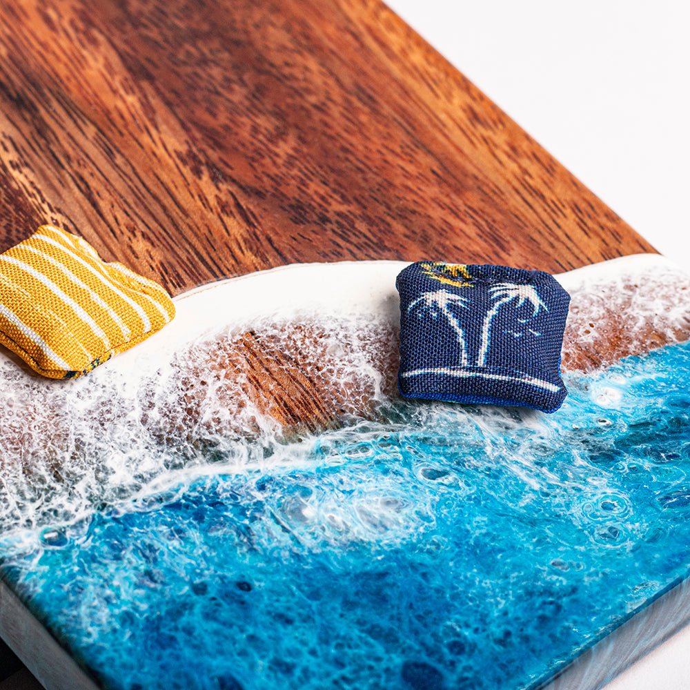 Decorative setting with a blue resin surface, white foam, and wooden elements.