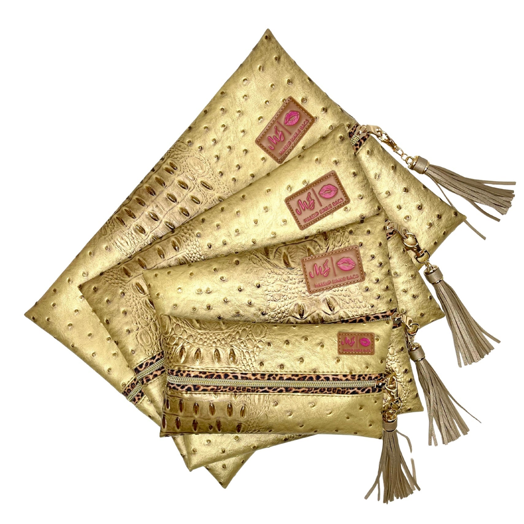 Set of gold clutch bags with tassels and visible brand logo on a white background