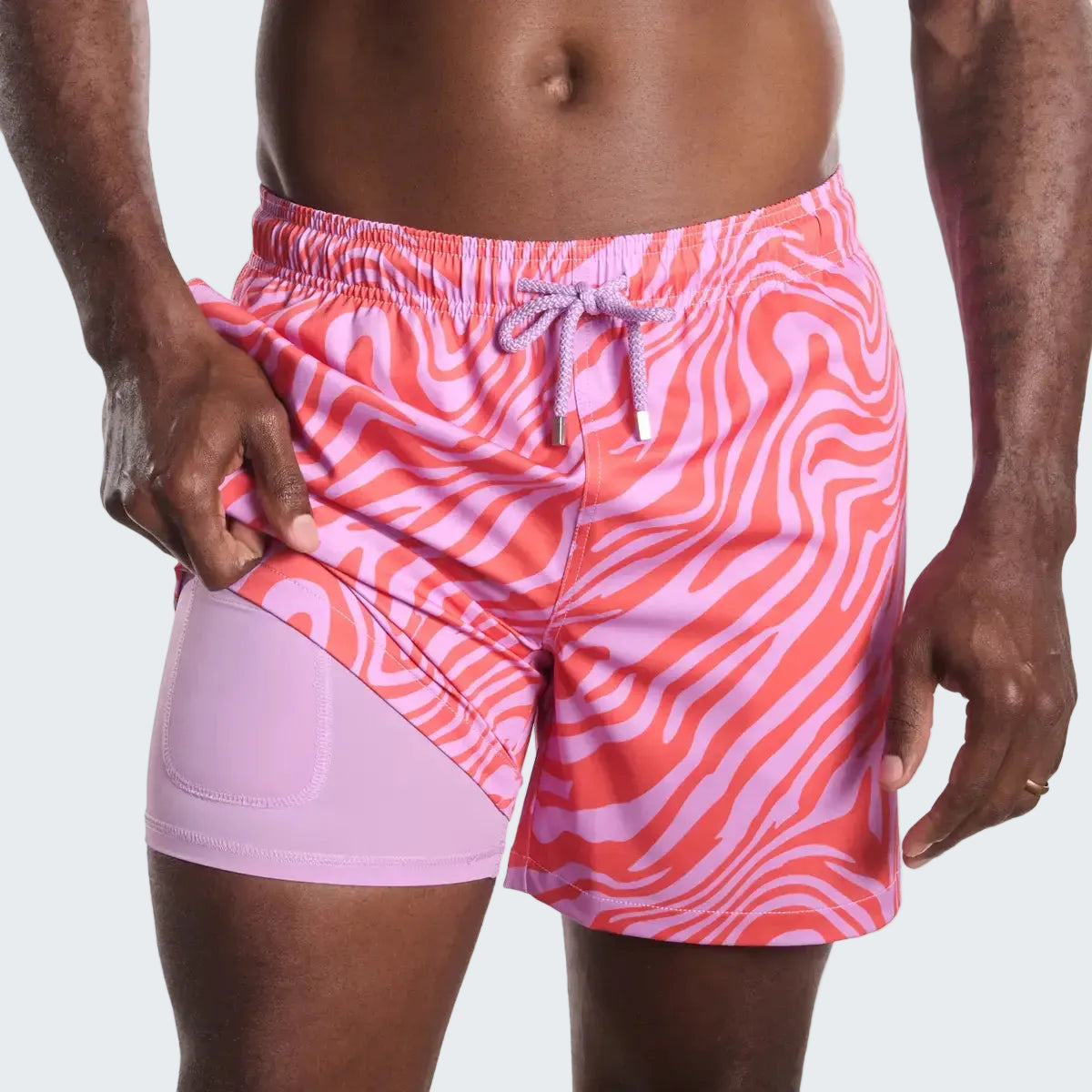Pink and purple patterned swim shorts on a white background