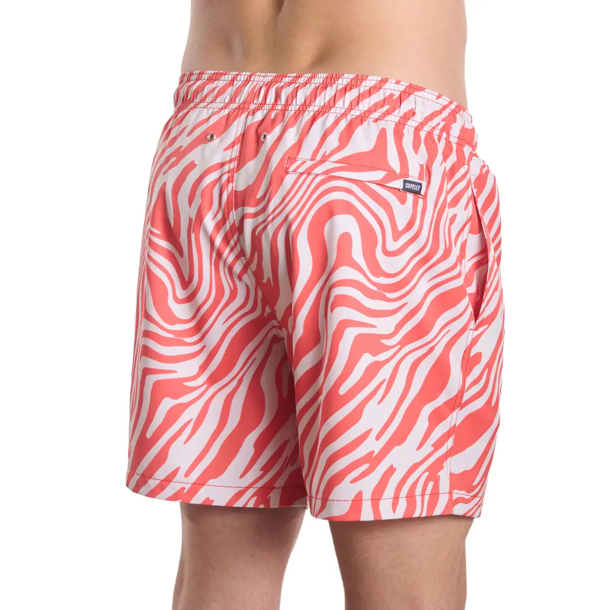 Red and white patterned swim shorts on a white background