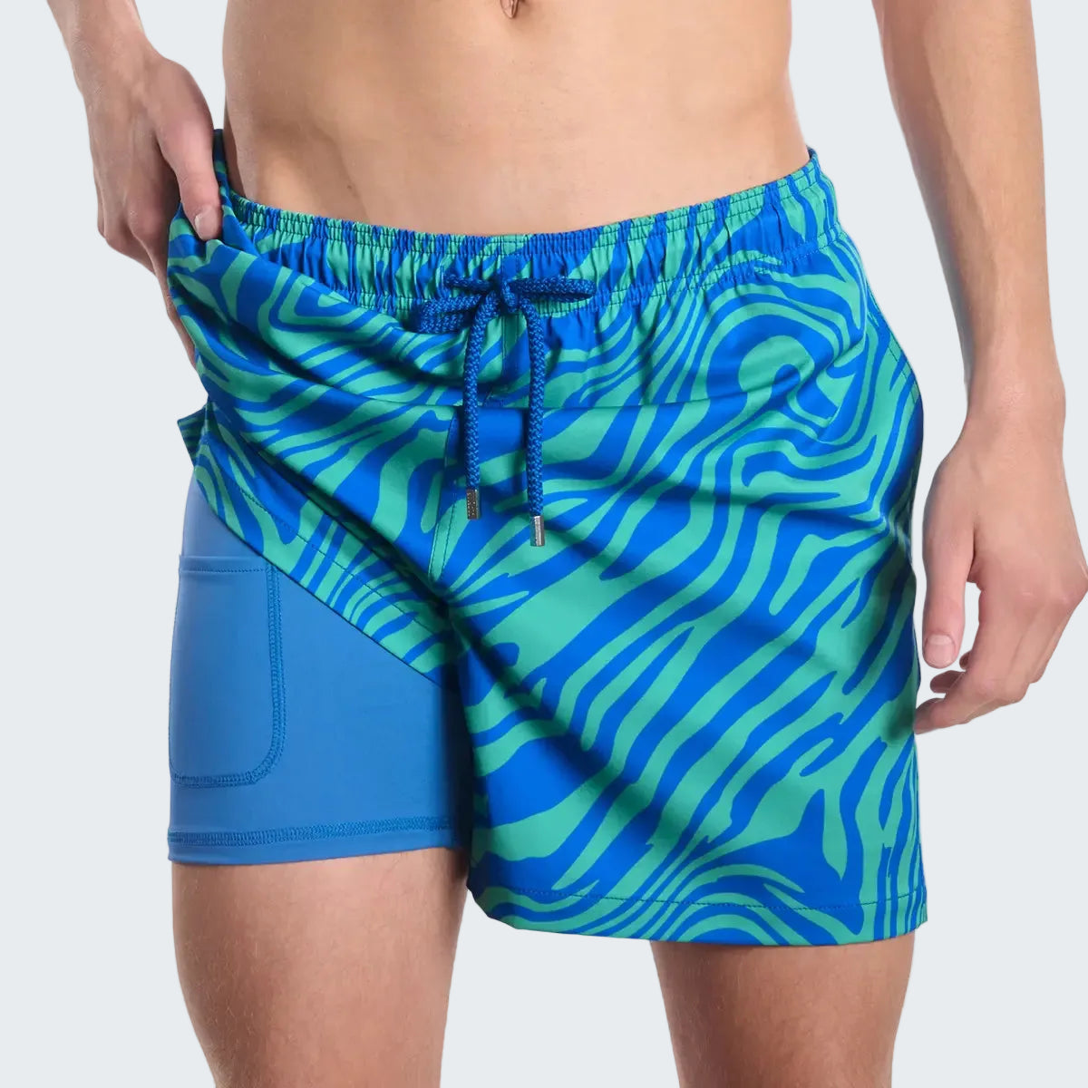 Blue and green patterned swim shorts on a white background