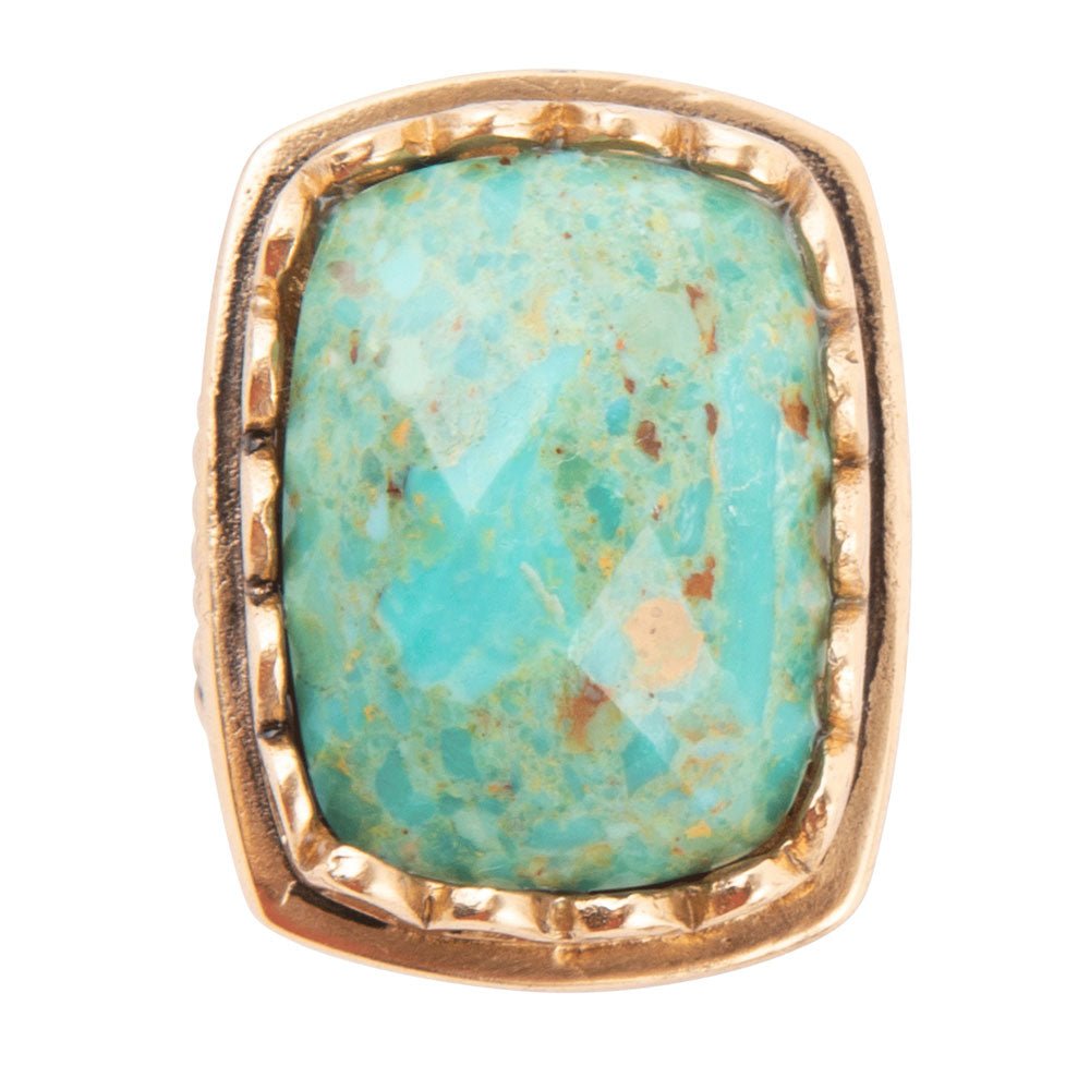 Turquoise stone ring with gold band on a white background