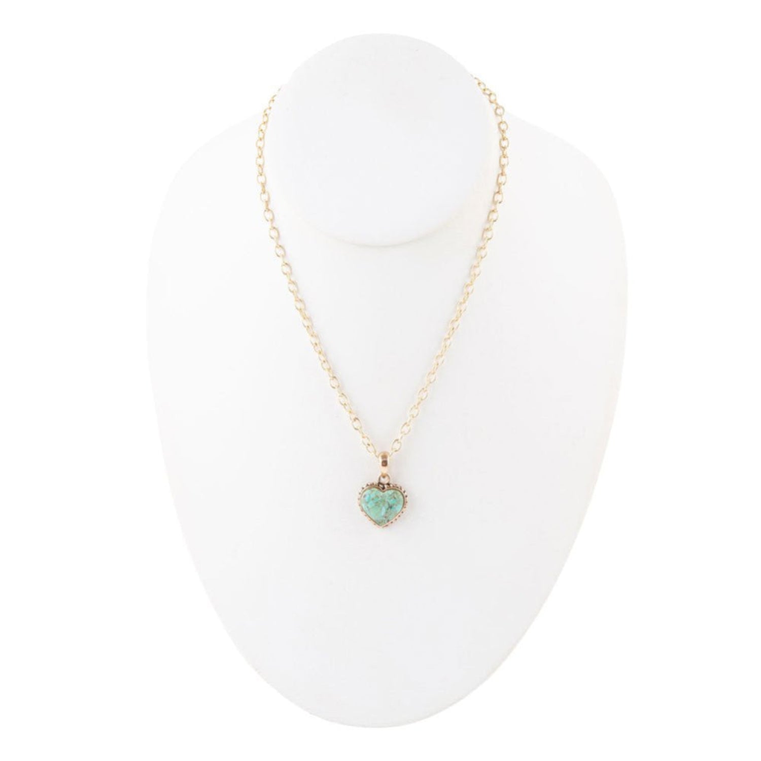 Necklace with a heart-shaped turquoise pendant on a white stand
