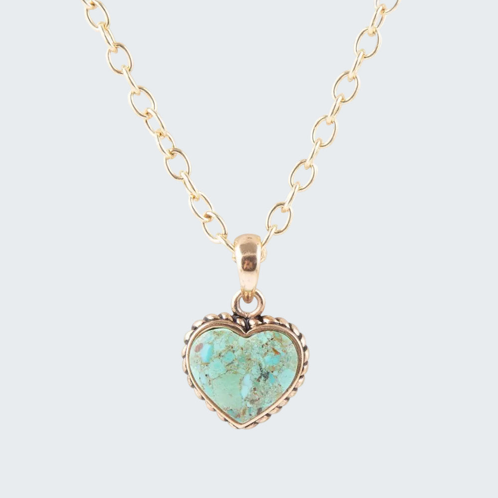 Turquoise heart-shaped pendant on a gold chain against a white background