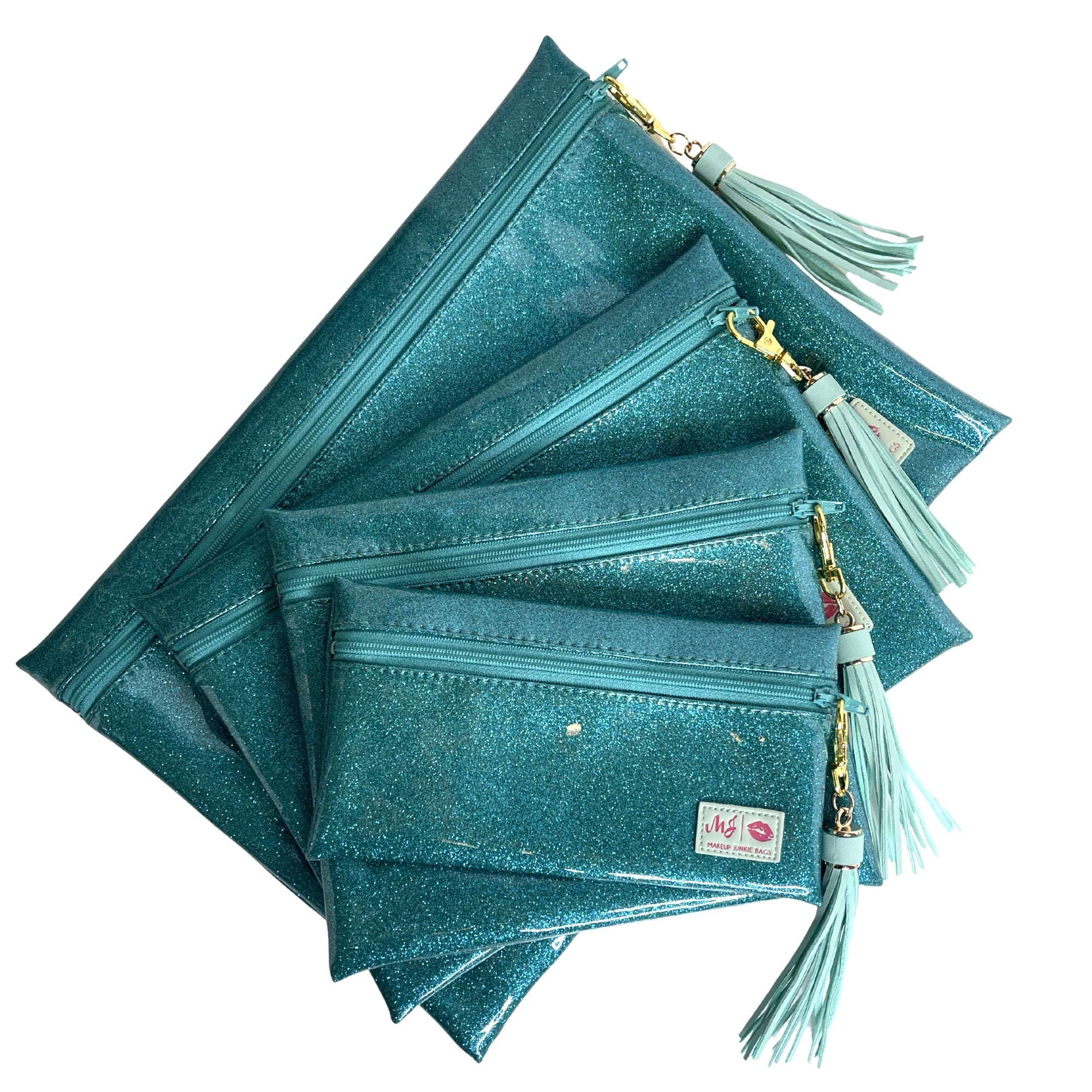 Stack of teal glittery pouches with tassels on a white background