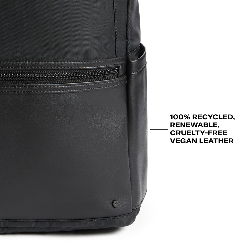Black vegan leather bag with text indicating recycled, renewable, cruelty-free material on a white background