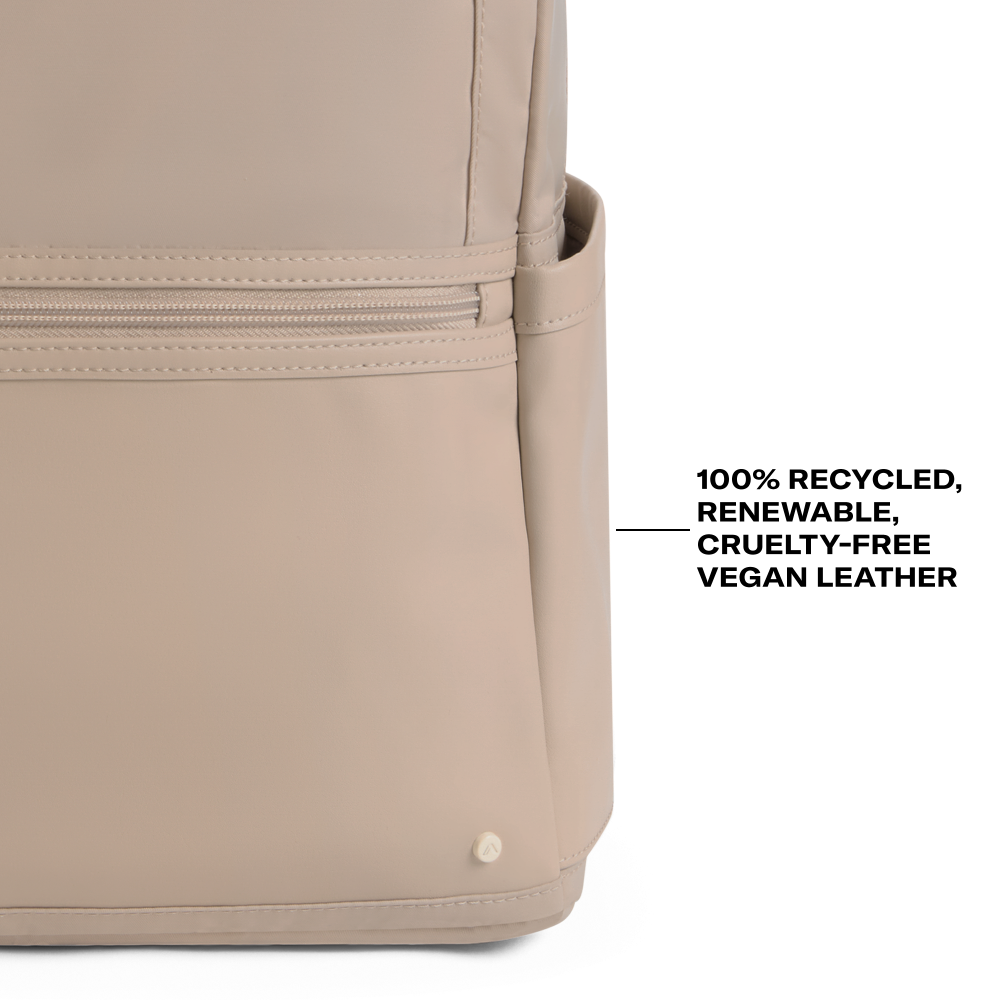 Beige backpack with text indicating '100% recycled, renewable, cruelty-free vegan leather' on a white background.