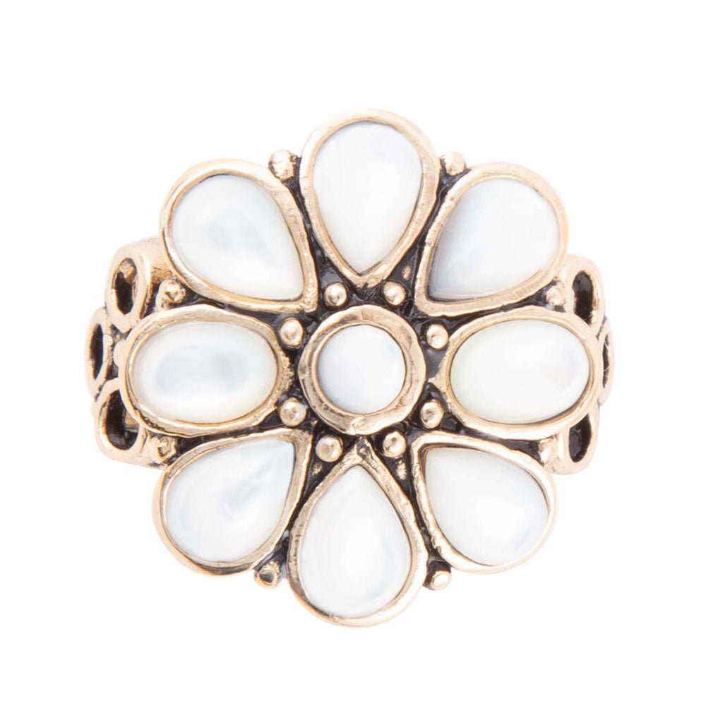 Gold ring with white teardrop-shaped stones on a white background
