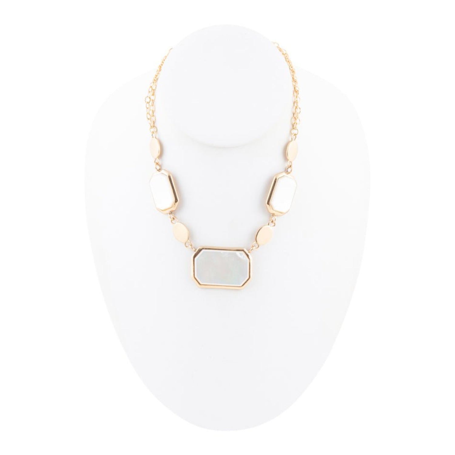Gold necklace with a central stone on a white background