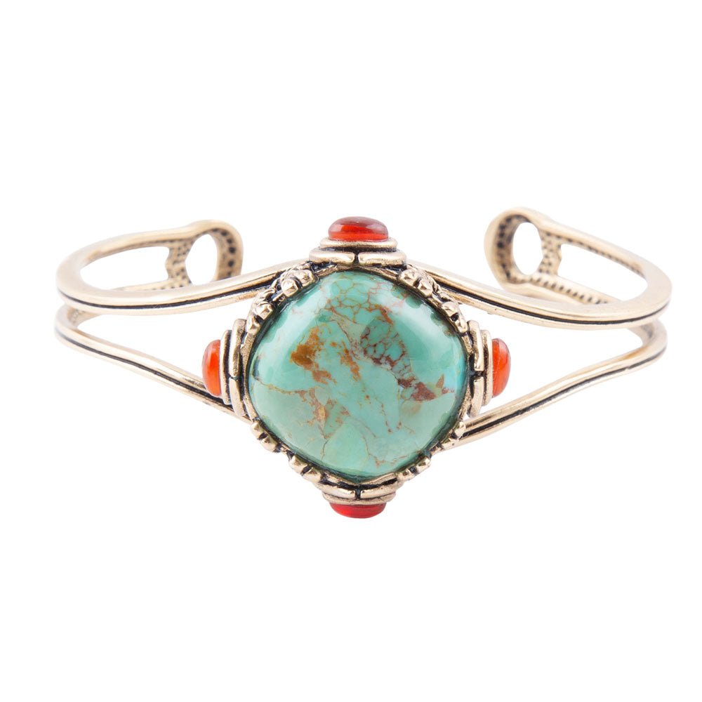 Turquoise stone bracelet with red accents on a white background