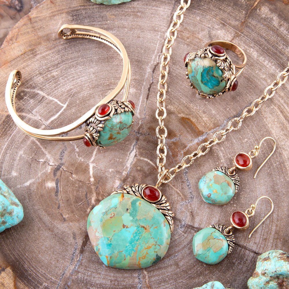 Jewelry set with turquoise stones and gold accents on a wooden surface