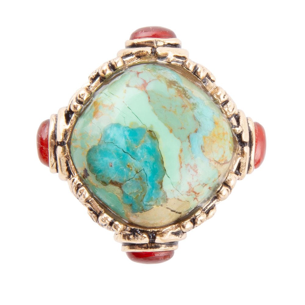 Ring with turquoise stone and coral accents on a white background