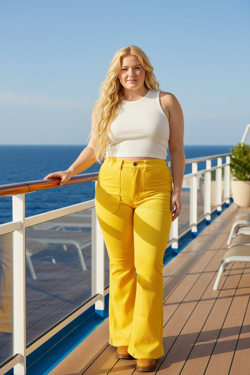 Woman wearing yellow pants and a white top on a white background