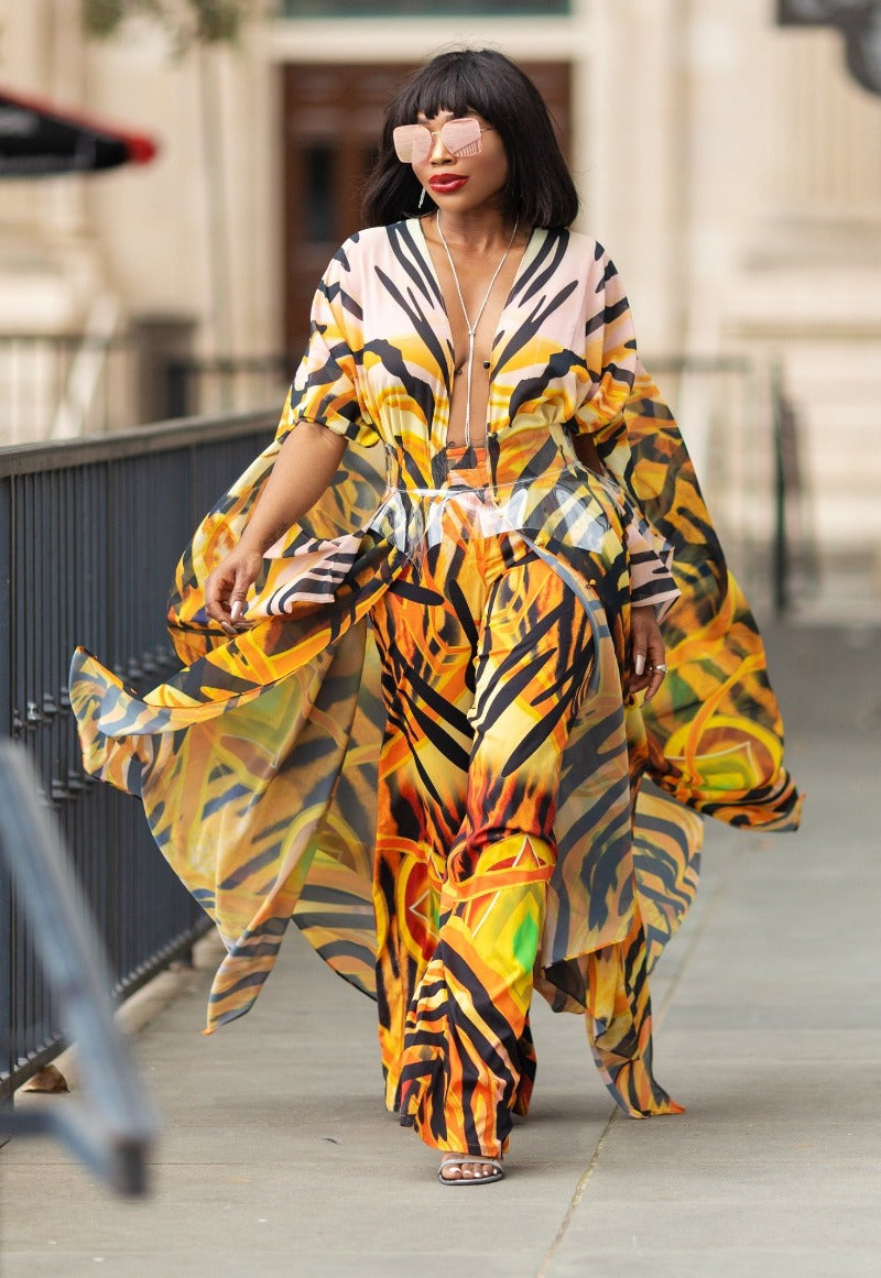 Woman wearing a colorful, patterned dress walking outdoors.