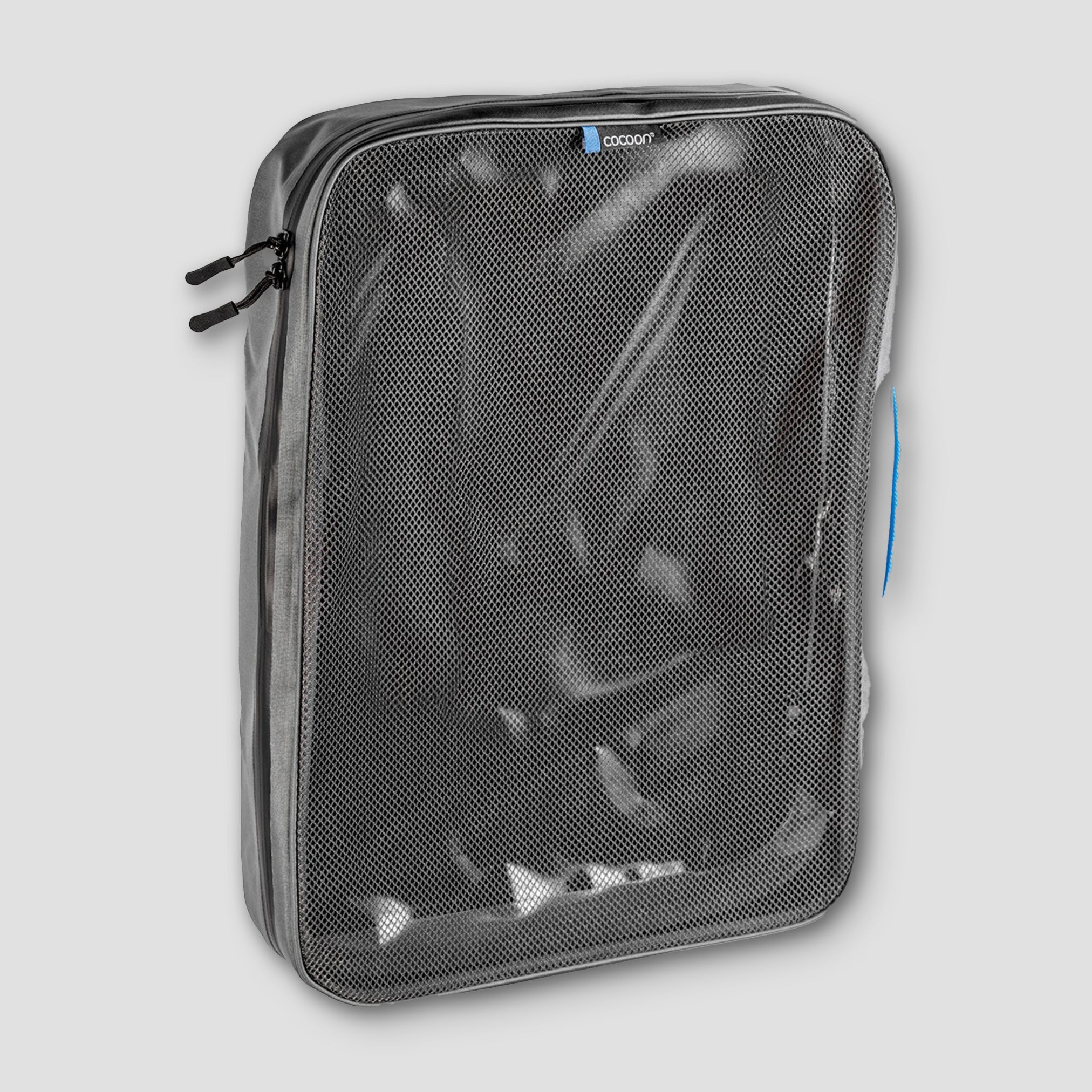 Clear travel organizer with mesh pocket on a light gray background