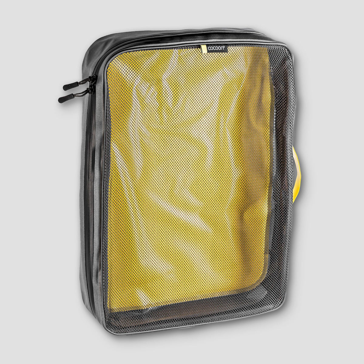 Yellow travel organizer in a clear bag on a light gray background