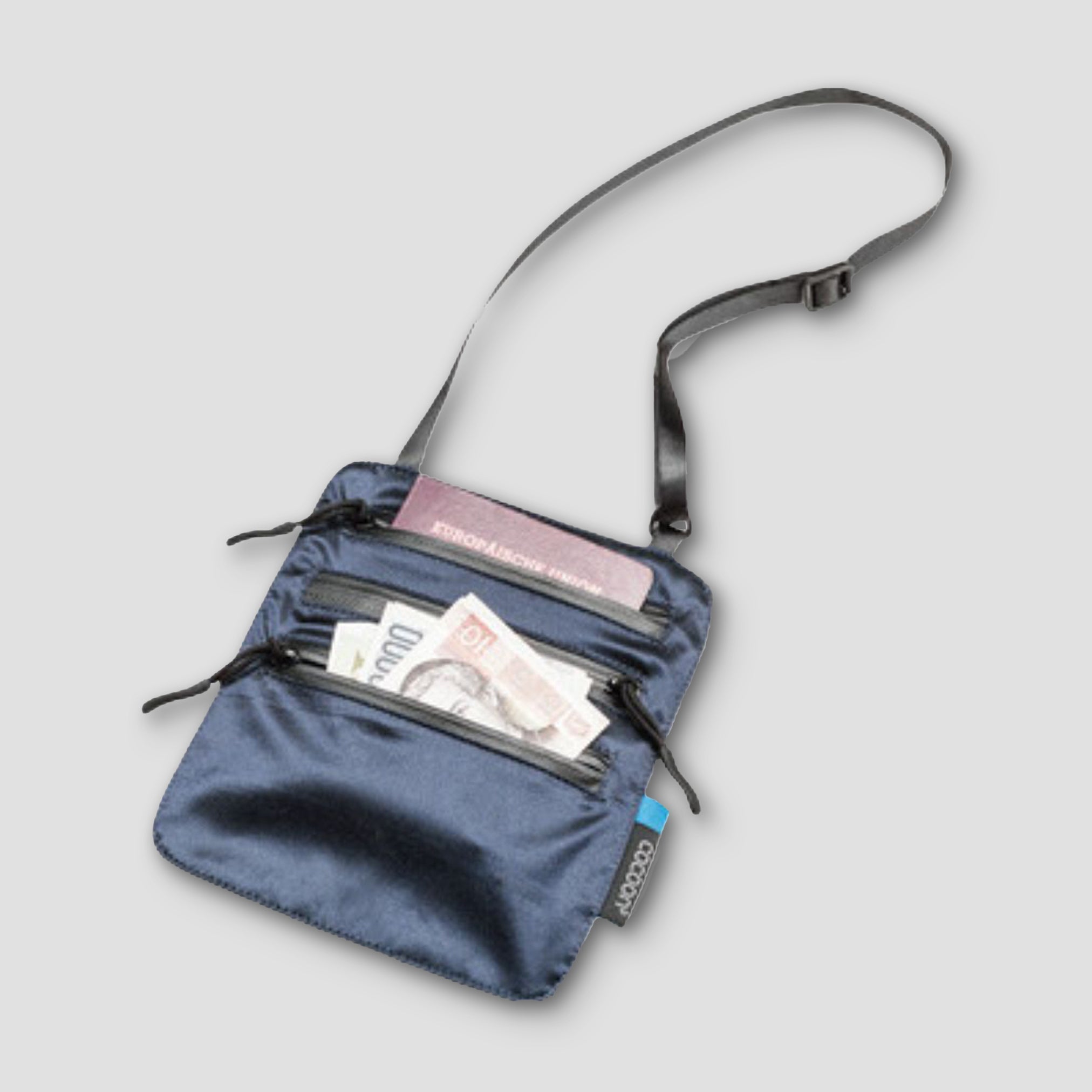Blue crossbody bag with money and a passport on a light gray background