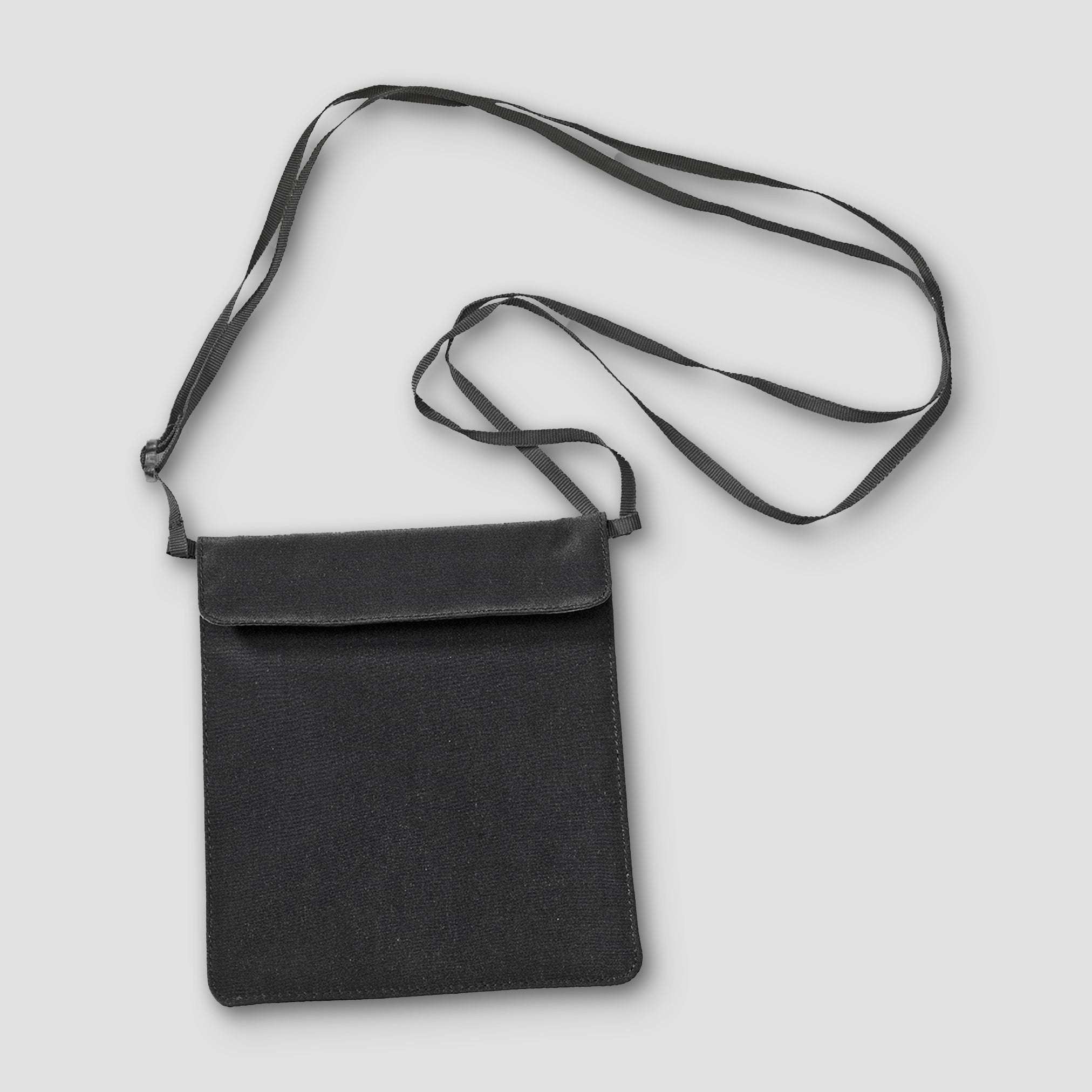 Black crossbody bag with a strap on a light gray background