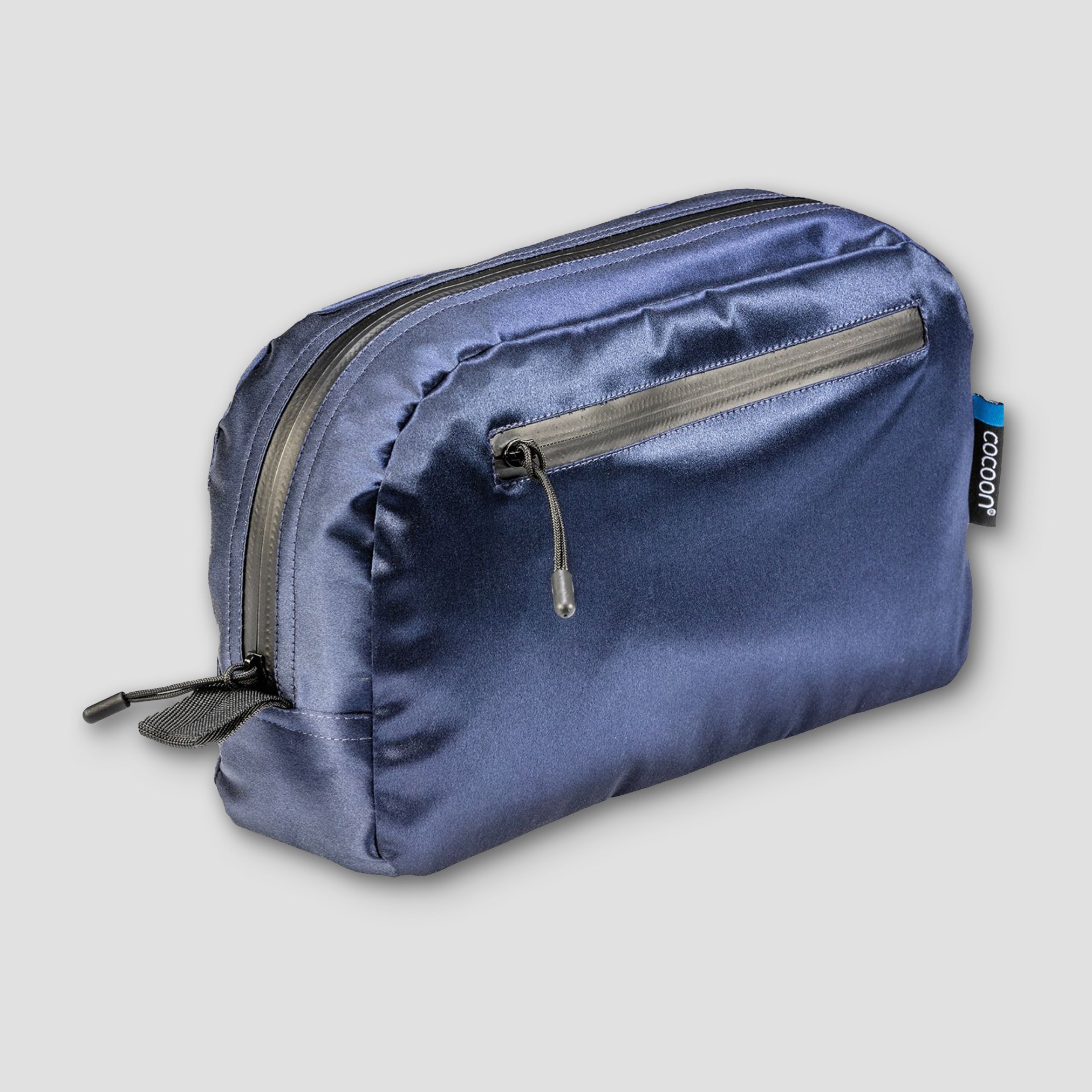 Blue satin toiletry bag with a zipper on a light gray background